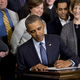 President Barack Obama signs a presidential memorandum increasing workers’ overtime protections during an event in the East Room of the White House, March 13, 2014.
SAUL LOEB/AFP/Getty Images